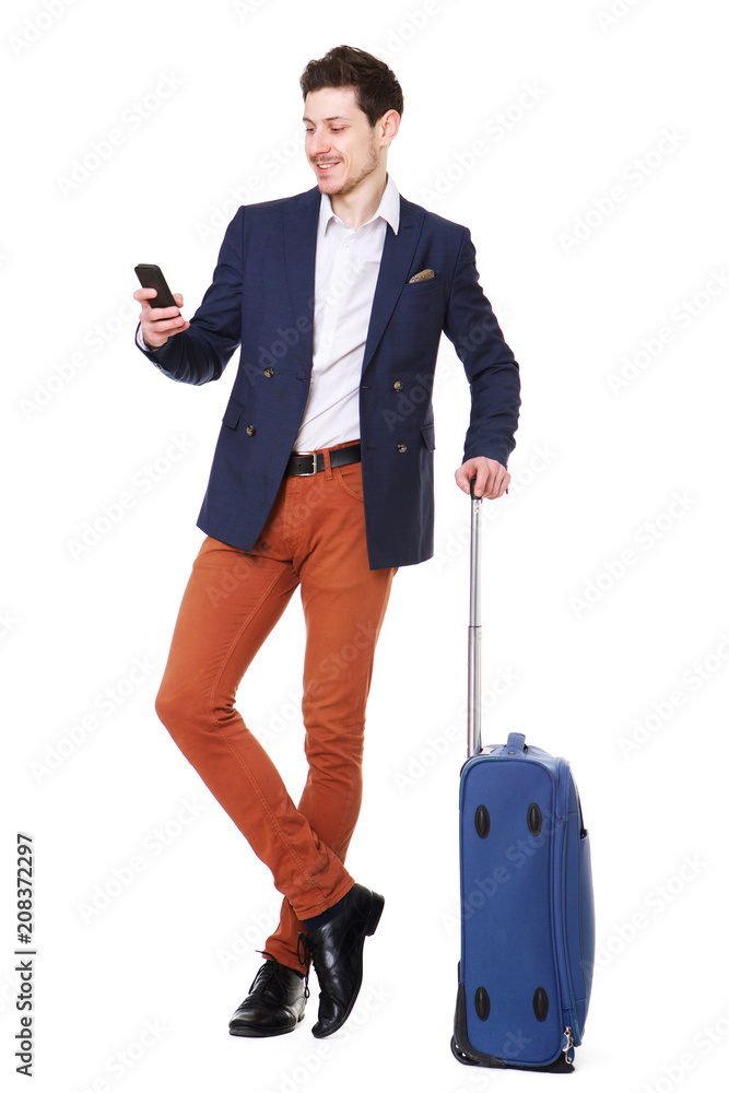 young businessman with luggage looking at mobile phone young businessman with luggage looking at mobile phone