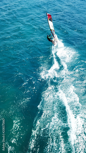 Aerial drone bird's eye view photo of competition surfers in tropical wavy clear waters © aerial-drone