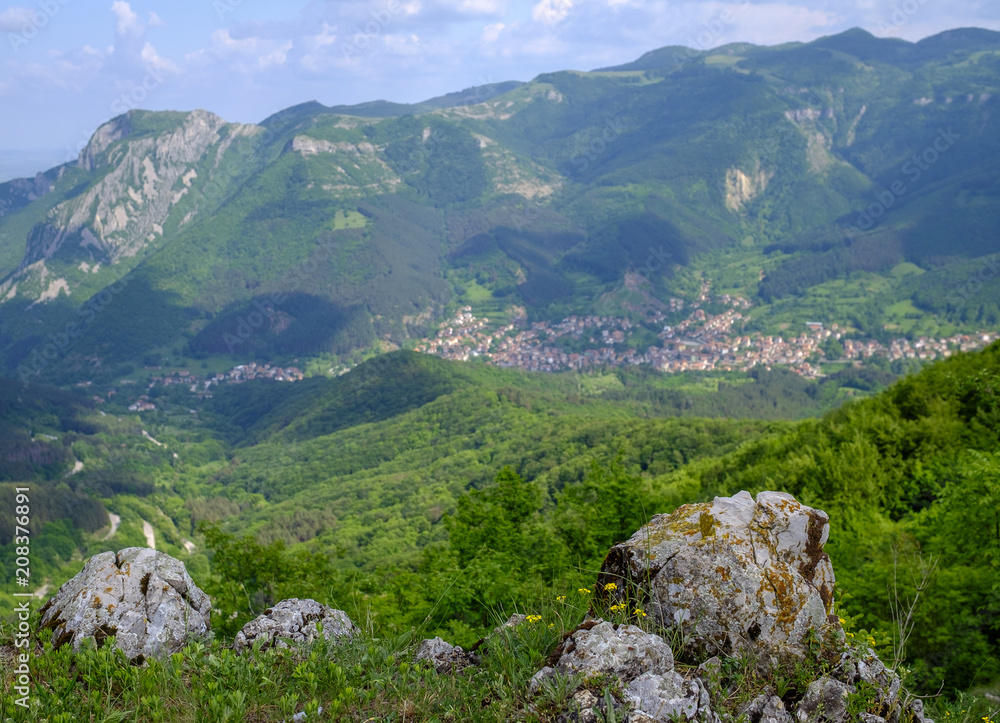 Mountain landscape with a village in the lowlands