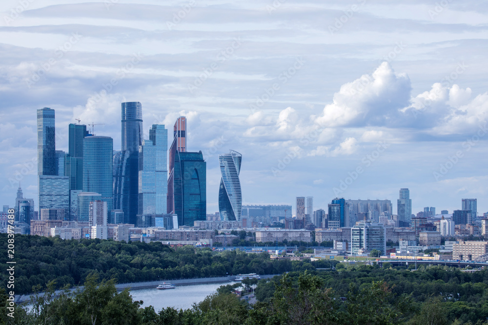 The panorama of Moscow, Russia wth Moskva city skyscrapers. The view from the observation platform of Sparrow Hills in the cloudy summer day