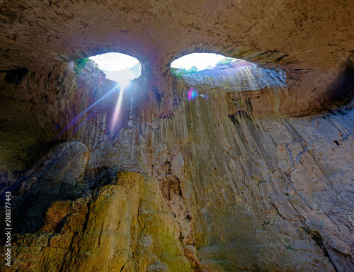 Panorama of the cave with holes in the form of eyes 2