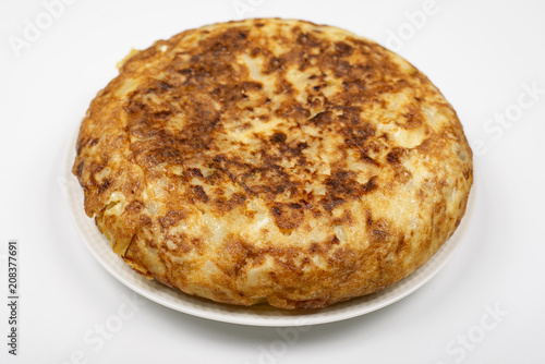 Omelette with potatoes on white background, isolated. Typical spanish food.