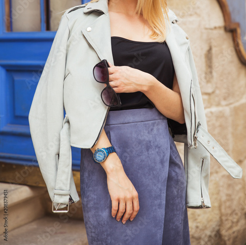 Blonde woman in black shirt and blue suede skirt