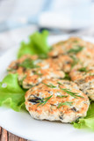 Homemade chicken and mushroom cutlets with salad, dill and cucumbers on dark wooden background. Healthy dinner or lunch.