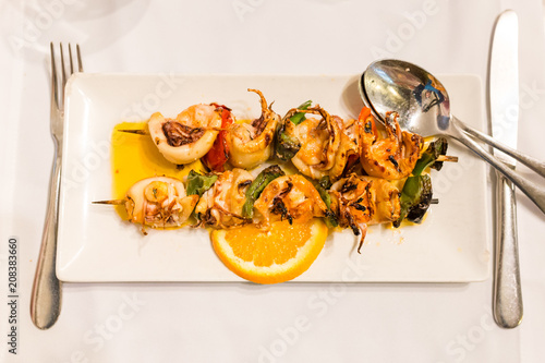 Traditional portuguese dish: Espetada de Lulas e Gambas (skewer with squid and king prawns) photo
