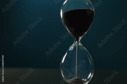 Crystal hourglass on color background. Time management concept