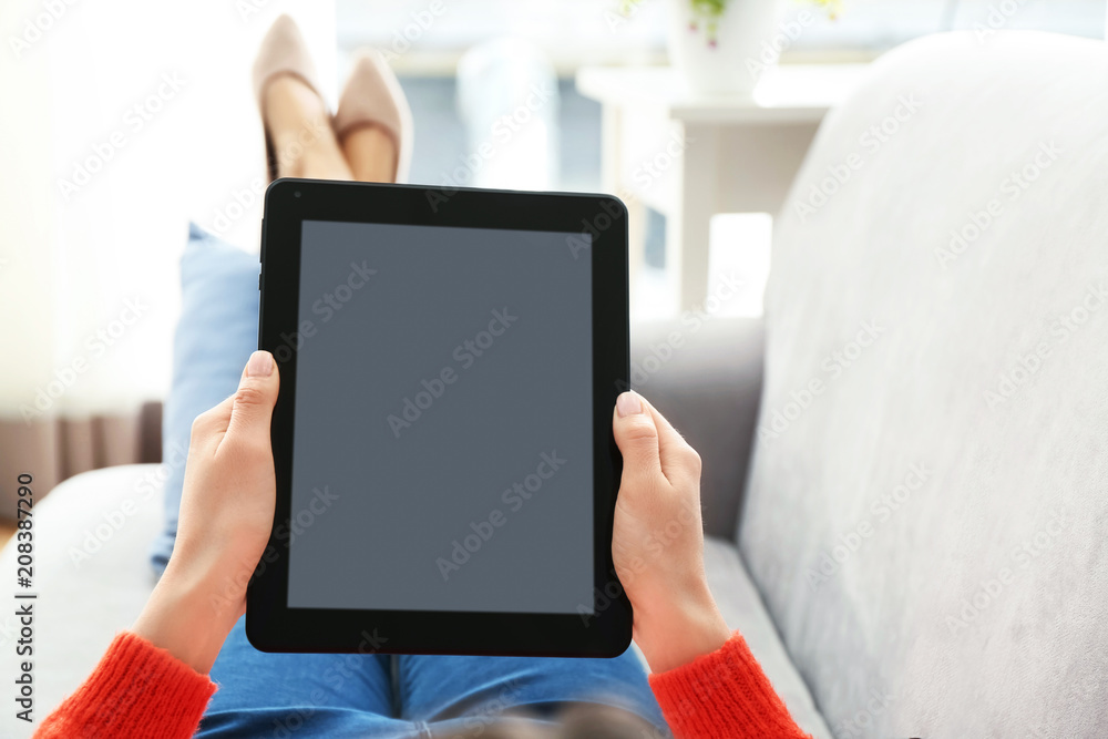 Young woman using tablet computer at home