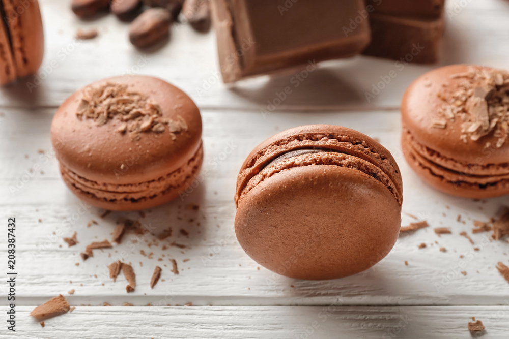 Delicious chocolate macarons on wooden background Delicious chocolate macarons on wooden background
