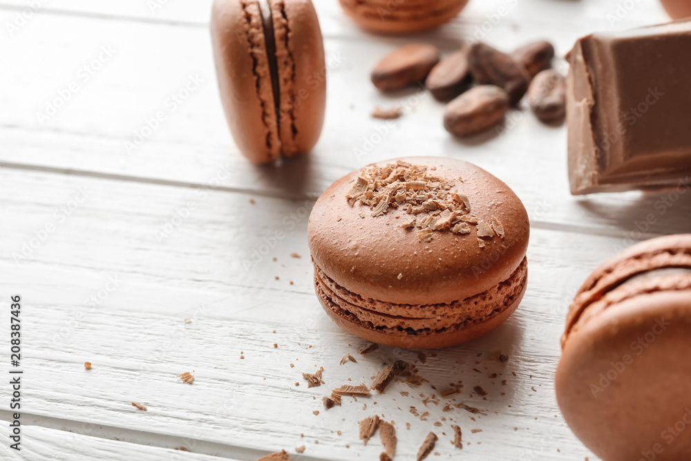 Delicious chocolate macarons on wooden background Delicious chocolate macarons on wooden background
