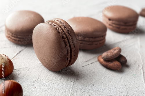 Delicious chocolate macarons on grey background