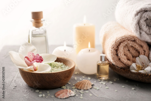 Spa composition with sea salt  flower and towels on light background