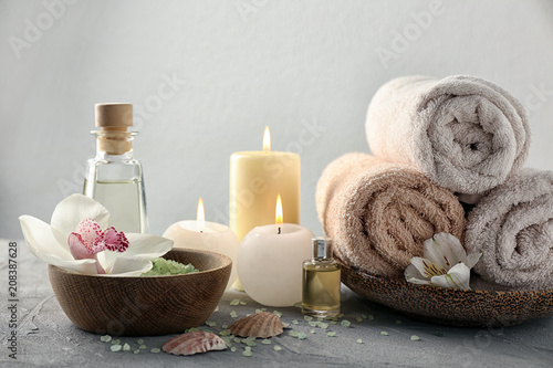 Spa composition with sea salt, flower and towels on light background