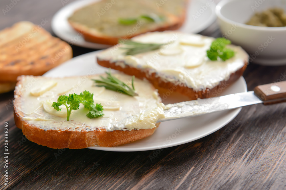 Tasty toasted bread with butter on plate
