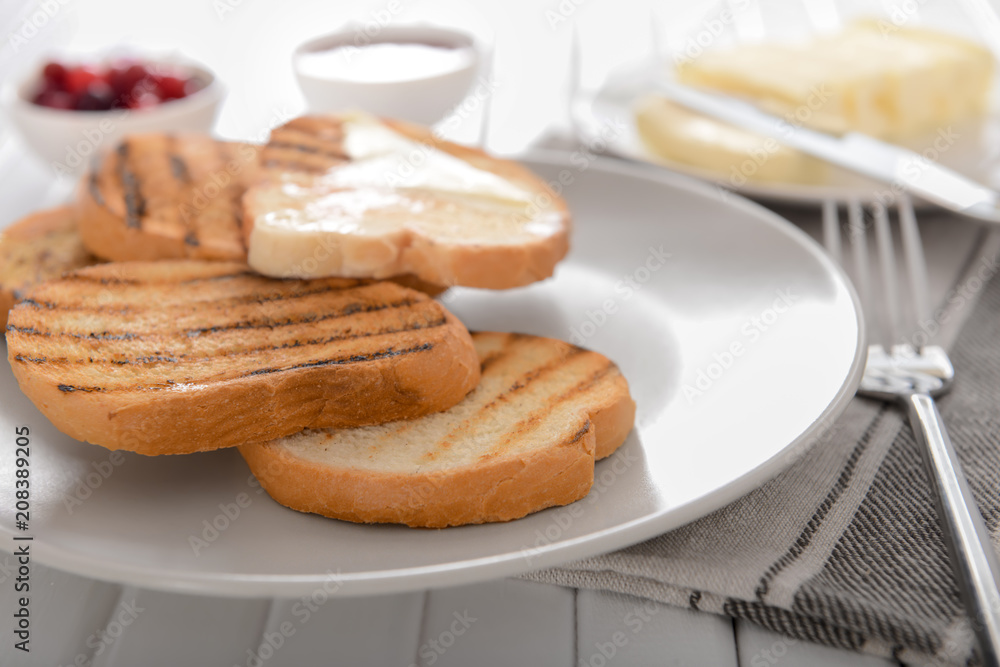 Tasty toasted bread with butter on plate Tasty toasted bread with butter on plate