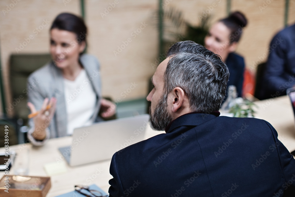 © Maskot - Businessman listening to colleagues during meeting at office © Maskot - Businessman listening to colleagues during meeting at office