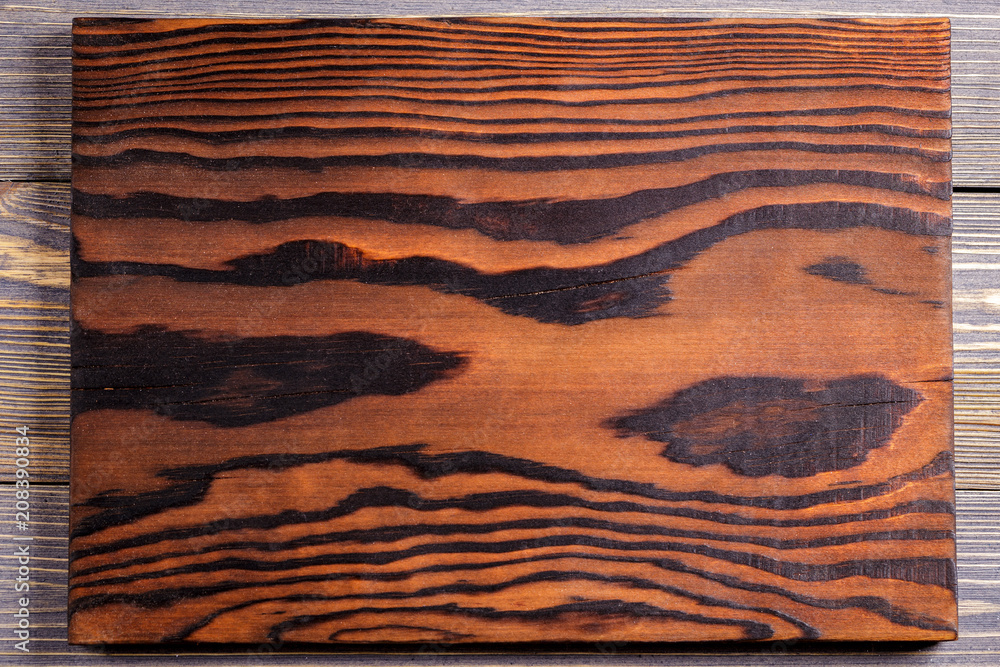 Cutting board from burnt wood. Wooden background. Cutting board from burnt wood. Wooden background.