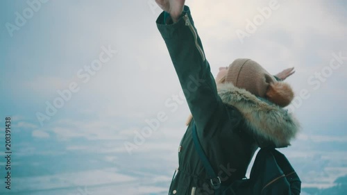 Woman with backpack hiking on mountain under blue sky with sunlight at sunny winter day, travel vacation, landscape mountains background.
