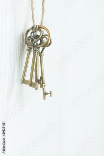 Vintage keys hanging on wall, key concept