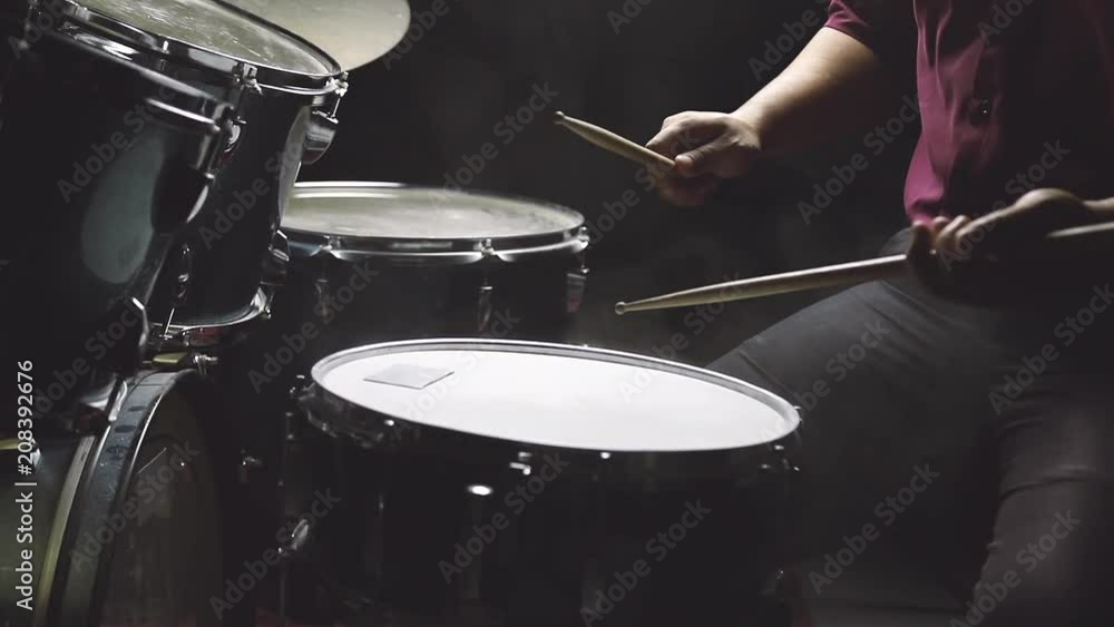 Dust from drum set with a man sitting in low light background, Cinemagraph. Dust from drum set with a man sitting in low light background, Cinemagraph.