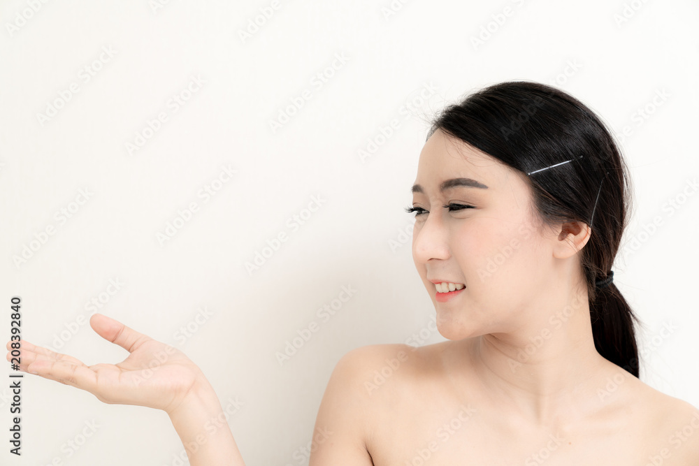 Asian beauty young woman close up head on face with white and healthy bright skin in motion use cometics treatment isolated on white background , included copyspace for advertise your product Asian beauty young woman close up head on face with white and healthy bright skin in motion use cometics treatment isolated on white background , included copyspace for advertise your product