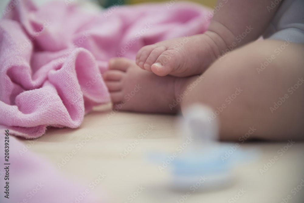 Small foots of newborn baby on pink blanket Small foots of newborn baby on pink blanket