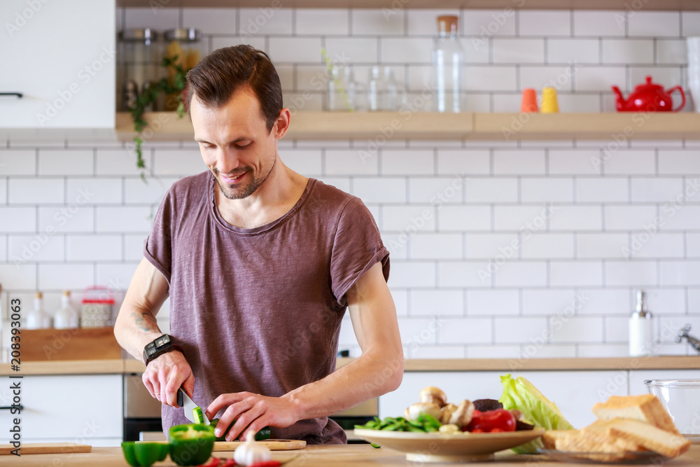Picture of man cooking vegetables on table Picture of man cooking vegetables on table