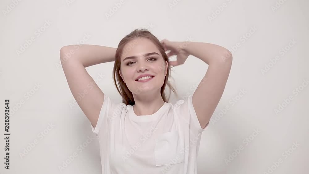 Beautiful girl with luxury hair posing on camera. Isolated on white background. Beautiful girl with luxury hair posing on camera. Isolated on white background.