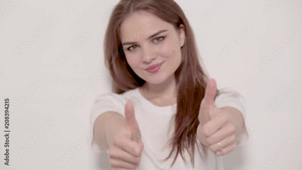 Sophisticated hands of girl showing thumbs on camera. Isolated on white background. Sophisticated hands of girl showing thumbs on camera. Isolated on white background.
