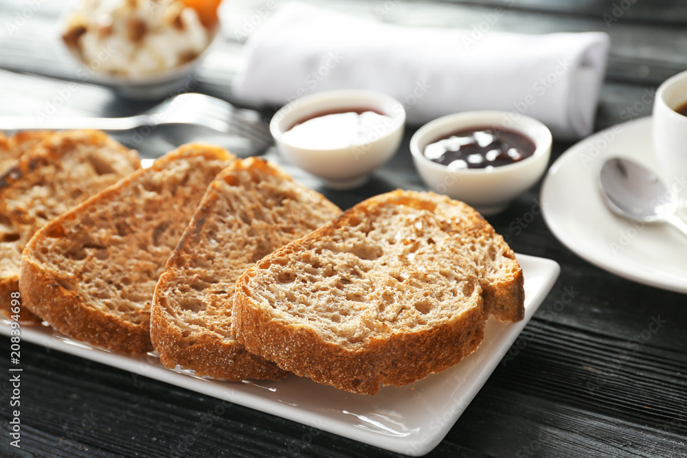 Plate with tasty toasted bread on table Plate with tasty toasted bread on table