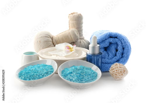 Beautiful spa composition with sea salt and herbal bags on white background