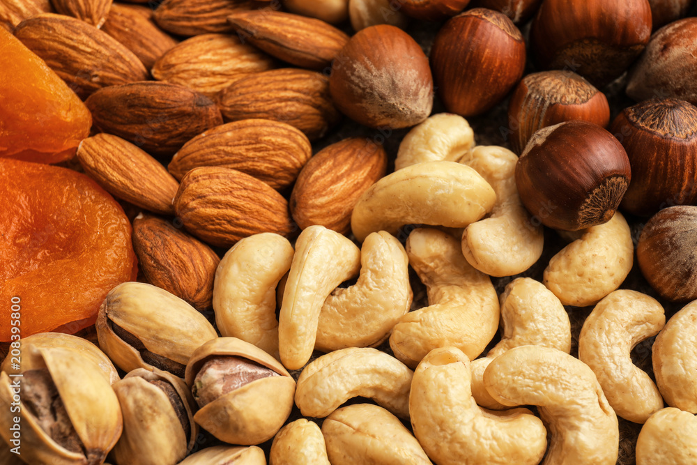 Obraz premium Different nuts, dried fruits and berries as background