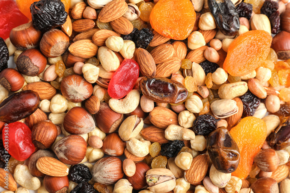 Different nuts, dried fruits and berries as background