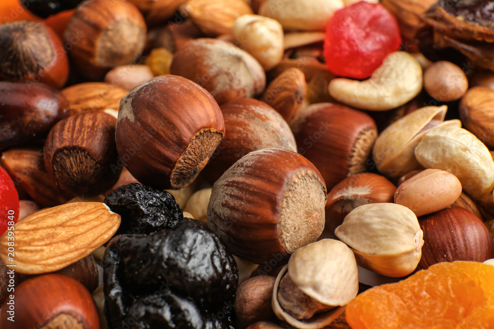 Different nuts, dried fruits and berries, closeup Different nuts, dried fruits and berries, closeup