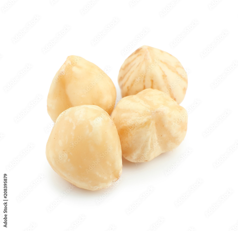 Peeled hazelnuts on white background