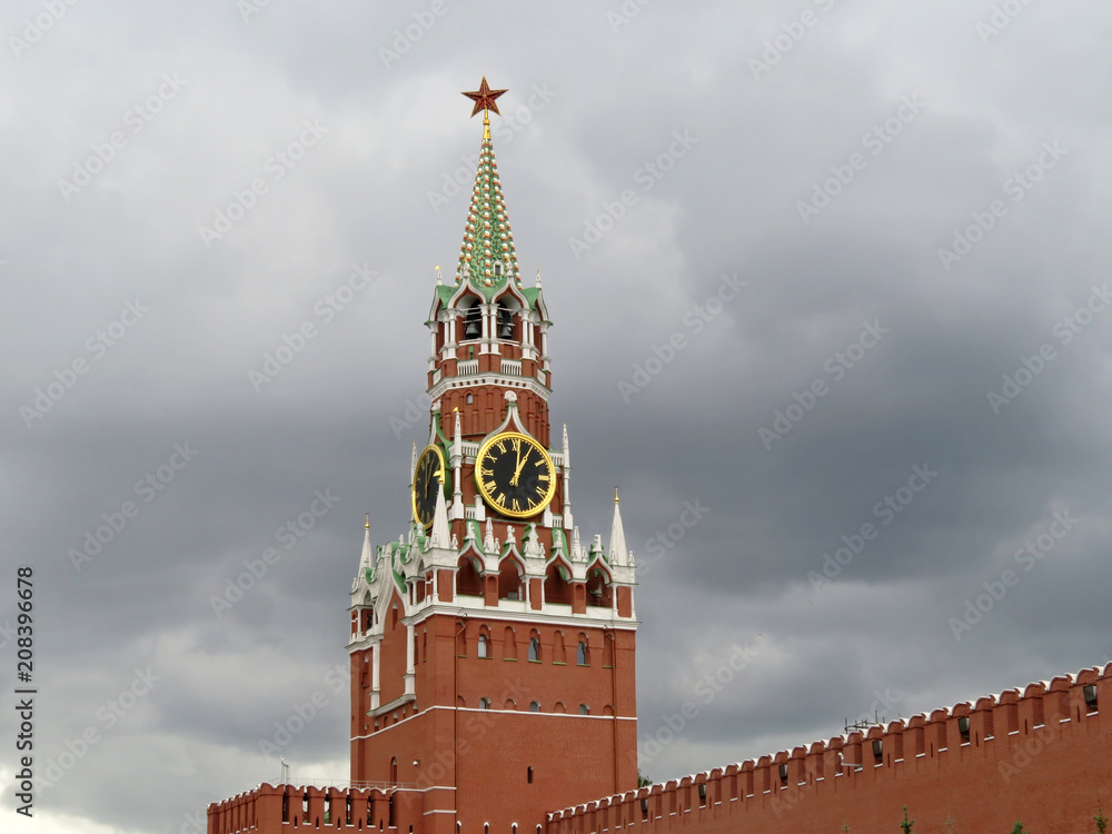 View of the Moscow Kremlin from Red square. Spasskaya tower on background of dramatic dark sky, symbol of Russia