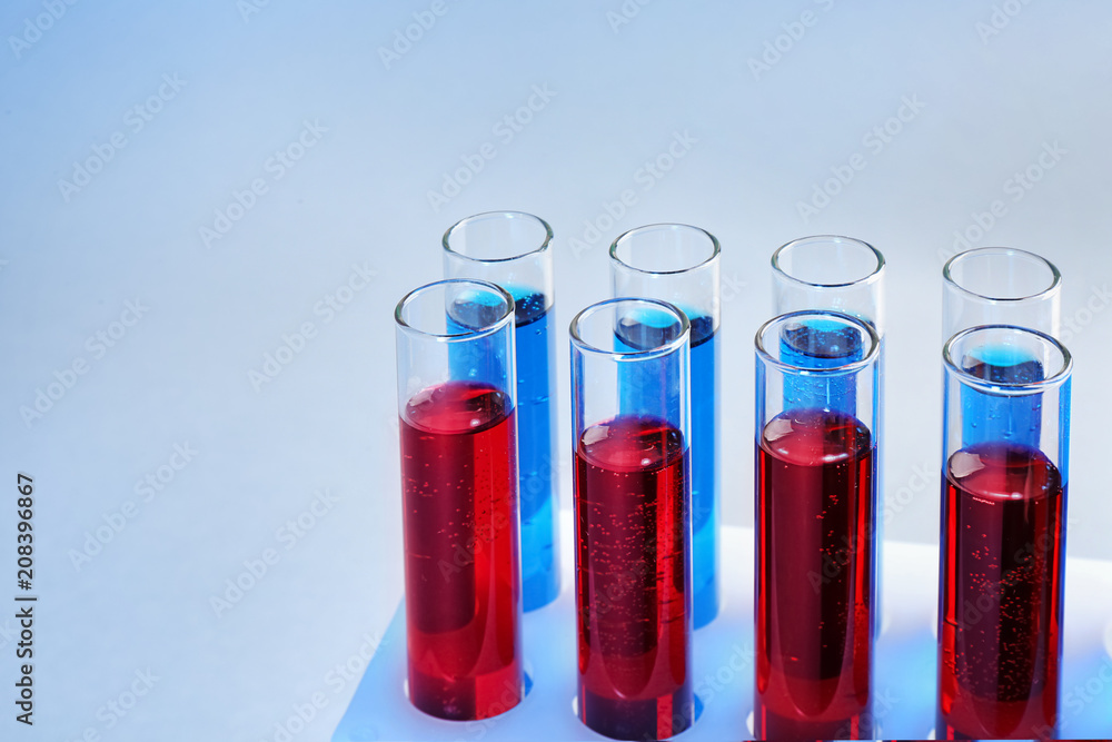 Test tubes with different liquids on color background Test tubes with different liquids on color background