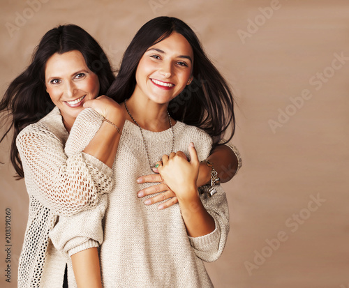 cute pretty teen daughter with mature mothr hugging, fashion style brunette photo