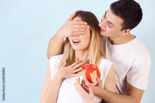 Young man giving present to...