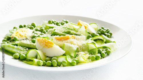 peas and pea pods, asparagus, cucumber fresh crunchy salad with added boiled egg and grated cheese dressed with vinegar and oil 
