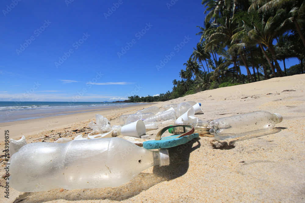 Plastic pollution on beach. Plastic bottles, bags and other garbage washes up in beach Plastic pollution on beach. Plastic bottles, bags and other garbage washes up in beach
