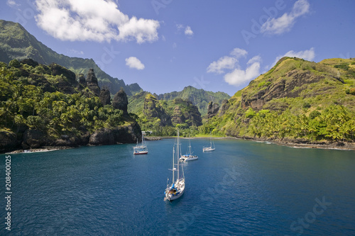 Sailing yachts anchoring in the Bay of Vergins, Marquesas Islands, French Polynesia photo