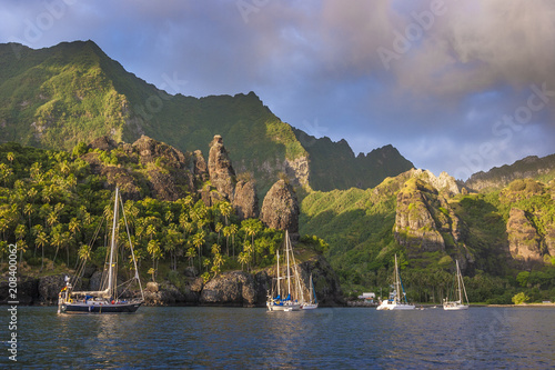 Sailing yachts anchoring in the Bay of Vergins, Marquesas Islands, French Polynesia photo