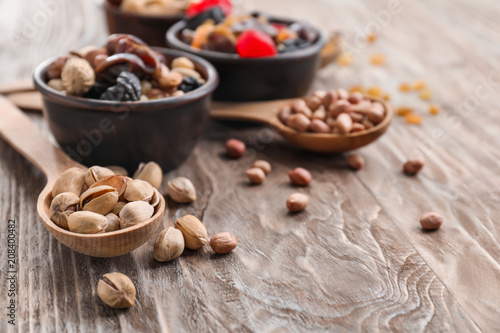 Composition with different kinds of nuts  dried fruits and berries on wooden background