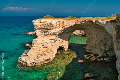 Scenic view of the "faraglioni" rocky cliffs of St. Andrew on the coast of Salento, in Apulia Italy.