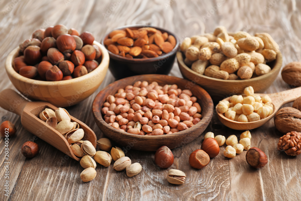 Composition with different kinds of nuts on wooden background