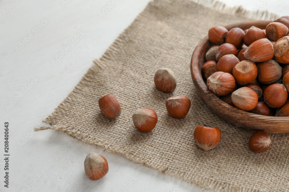 Plate with tasty hazelnuts on table Plate with tasty hazelnuts on table