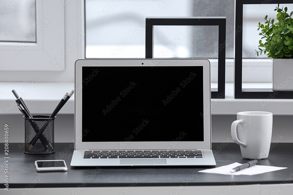 Stylish workplace with laptop on table Stylish workplace with laptop on table