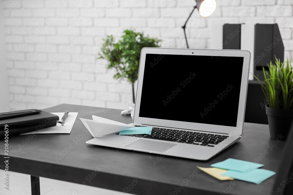 Stylish workplace with laptop on table Stylish workplace with laptop on table