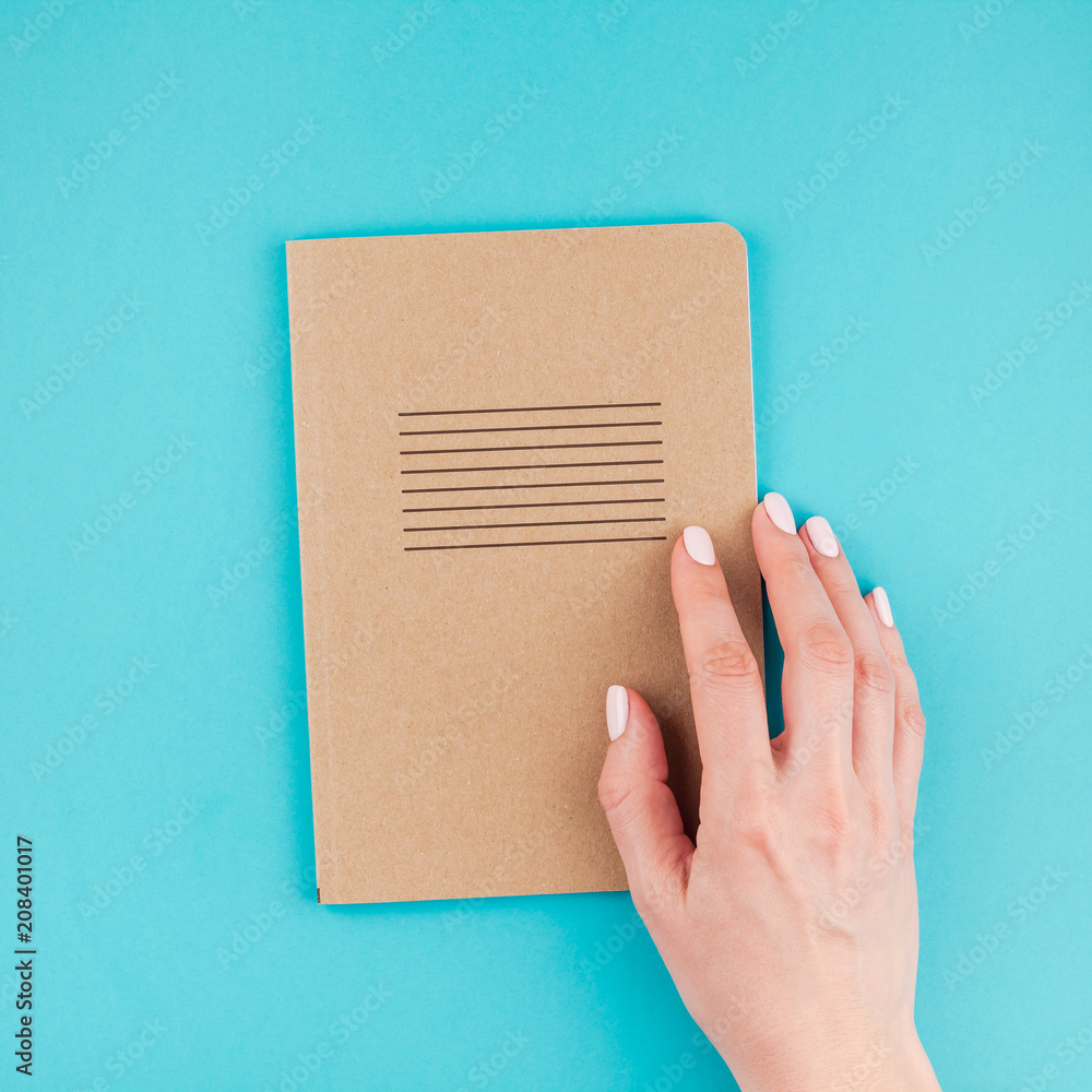 Woman hands holding craft paper diary Woman hands holding craft paper diary