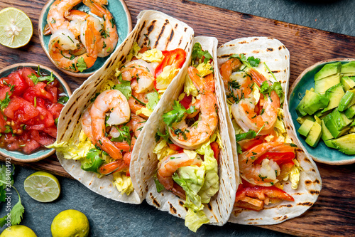 Shrimps tacos with salsa, vegetables and avocado. Mexican food